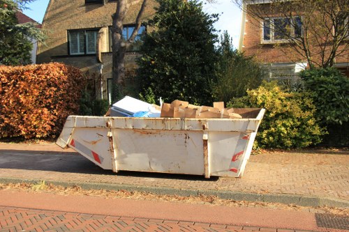 Professional waste collector managing household rubbish